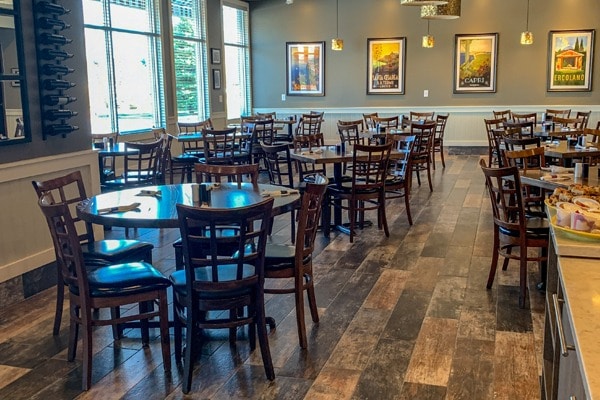 Danny-Zs Pub N' Grub interior with wooden floors of varying color and several dark wooden tables with chairs